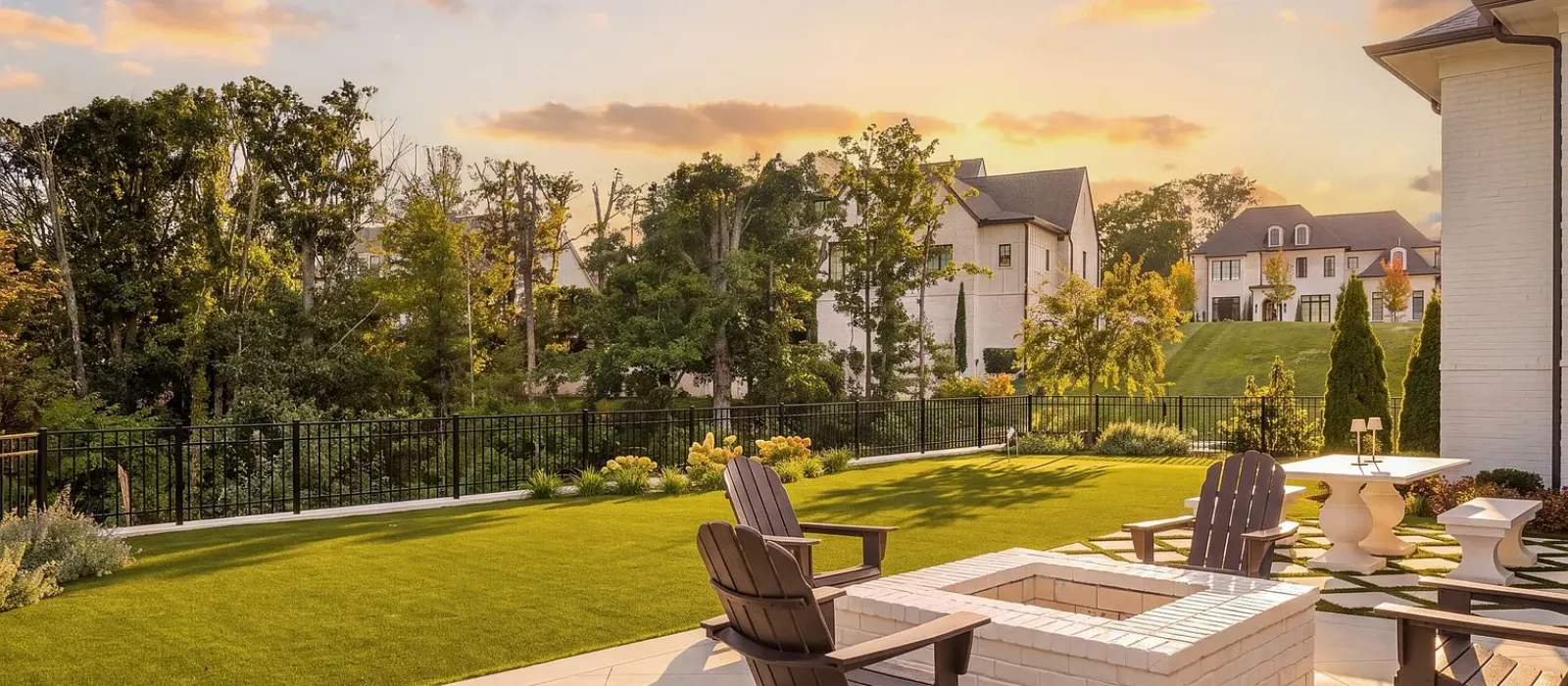 Artificial turf lawn beside a fire pit and patio seating area at sunset in Fort Mill, SC